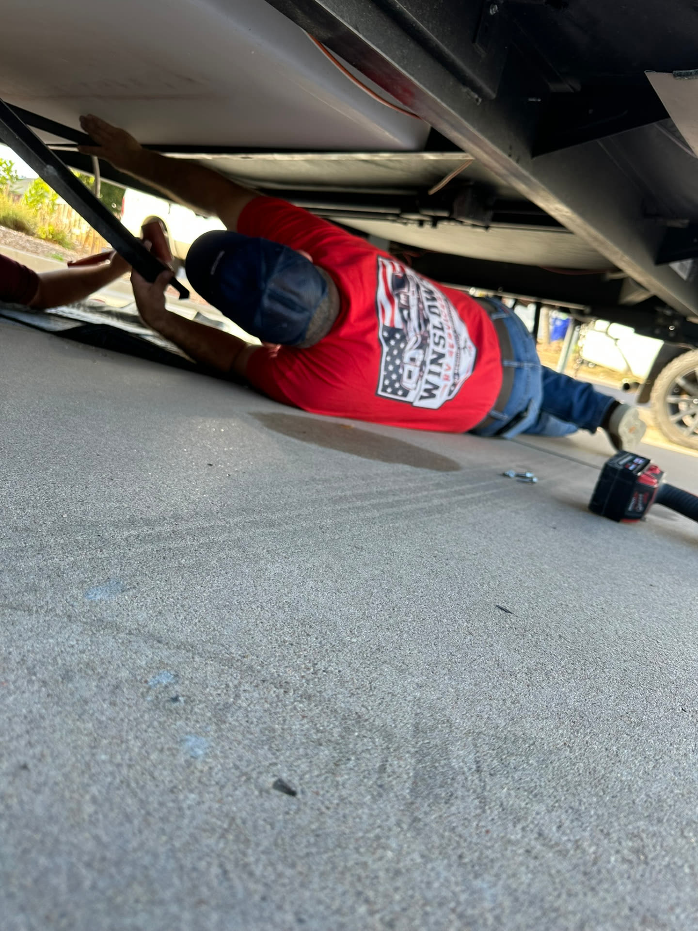 Winslow's RV Services tech working under a fifth wheel's underbelly