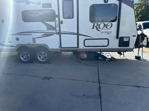 Rockwood Roo travel trailer receiving mobile service in a driveway