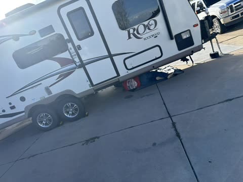 Travel trailer parked on a driveway during mobile service